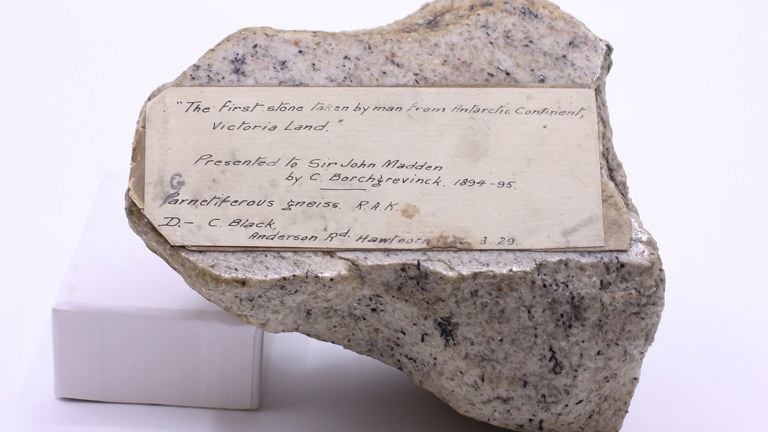 A speckled rock featuring a hand written label